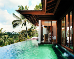 Infinity pool outside the Taramala retreat 1 bedroom villa with a view into the villa of personal assistant preparing the room