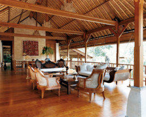 Lounge area of Como Shambhala’s Bayugita residence with tables and chairs and wooden features
