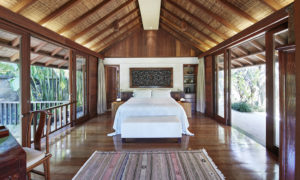 Master bedroom of Como Shambhala’s Gesing Kanila 2 bedroom villa featuring bed, carpet, and floor to ceiling windows